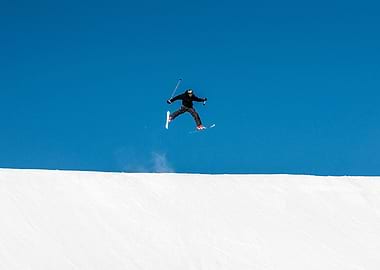 Skier Jumping Against Blue Sky