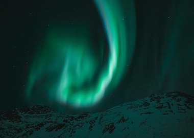 Aurora Borealis over snowy landscape