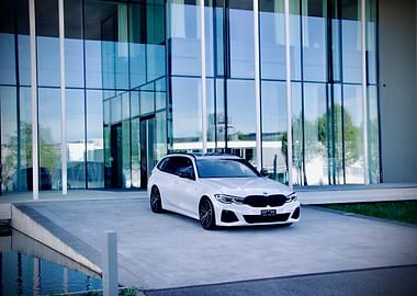 White BMW Touring in front of building