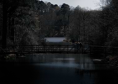 Bridge over water with two people