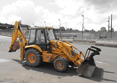 Yellow JCB Backhoe Loader on Asphalt