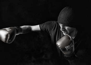 monochrome boxer punching with everlast gloves