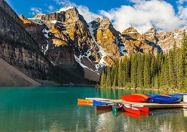 moraine lake with canoes and mountains