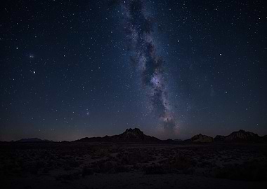 Milky Way over a dark landscape