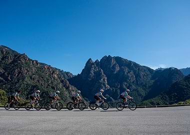 Cyclists riding in formation, mountain backdrop