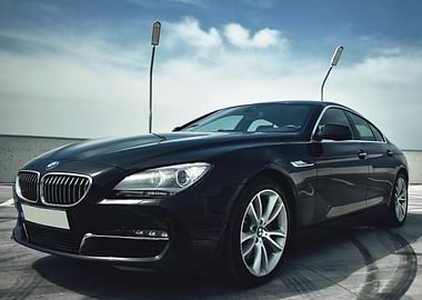 Black BMW on Rooftop Parking Lot