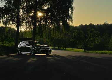 Black BMW M5 Touring Sunset