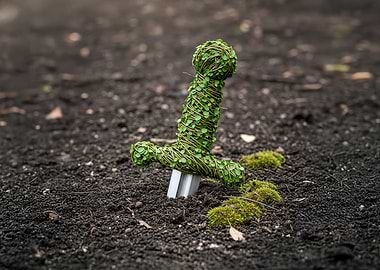 Sword in the ground covered in leaves