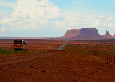 School Bus Driving through Monument Valley