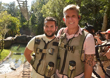Two Men Wearing Vests Outdoors