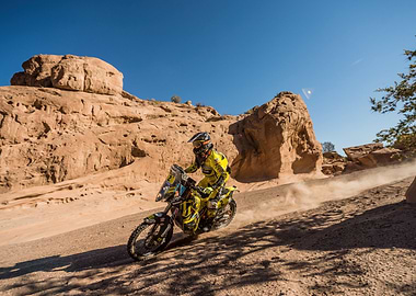 Motorcycle racing in desert landscape