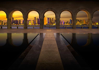 doha skyline through arches at sunset