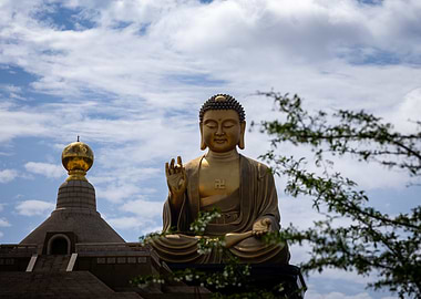 Golden Buddha Statue Under Cloudy Sky