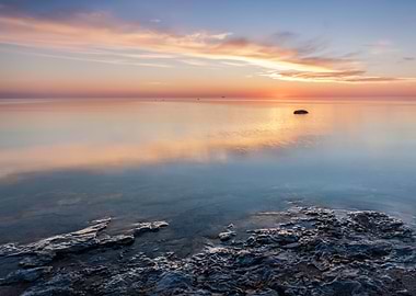 Serene Sunrise Over Calm Waters