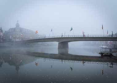 Foggy Bridge with Flags over Water