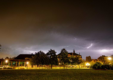 Night Lightning Over Buildings and Trees - Storm