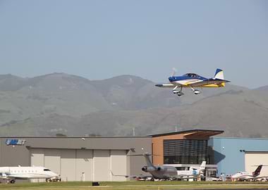 Blue and Yellow Airplane Taking Off