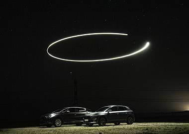 Cars under starry sky with light painting