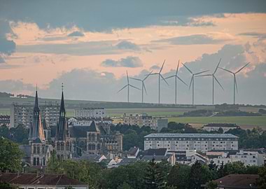 Cityscape with Wind Turbines at Sunset
