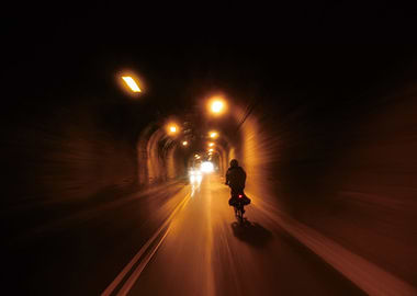 Cyclist in Tunnel at Night