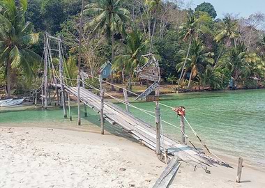 Tropical beach with wooden bridge