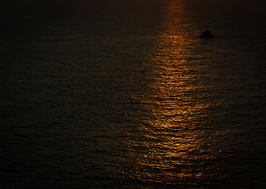 Golden Sunlight Reflection on Dark Ocean