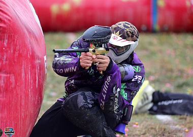Paintball Player Aiming with Gun