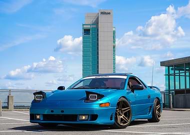 Teal Mitsubishi 3000GT with Hilton backdrop