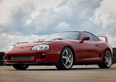 Red Mark4 a80 Toyota Supra under cloudy sky