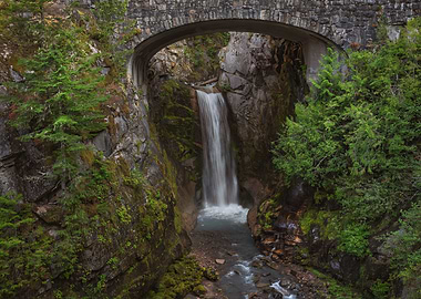 Waterfall under stone bridge in nature