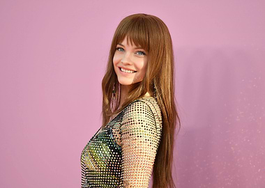 Barbara Palvin smiling on pink background