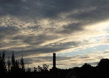 Silhouette of a Tower Under Cloudy Sky