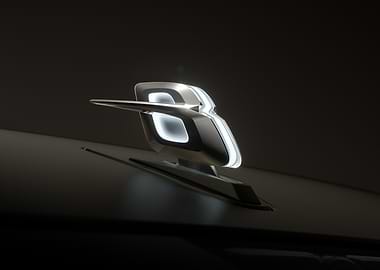 Illuminated Car Emblem on Dark Surface