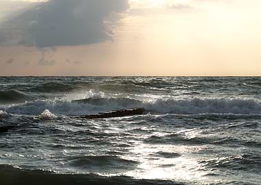 Waves crashing on a wooden breakwater