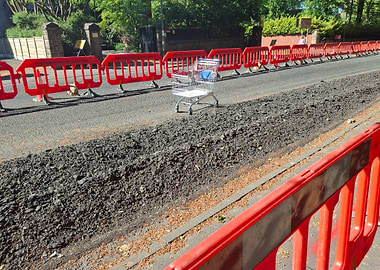 Shopping cart on road construction site