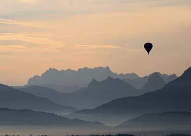 Hot air balloon over mountain range