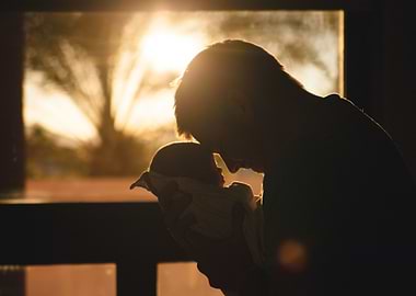 Father and Newborn Silhouette at Sunset
