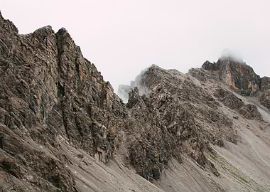 Rocky Mountain Peaks Under Cloudy Sky