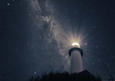 Lighthouse under the starry night sky