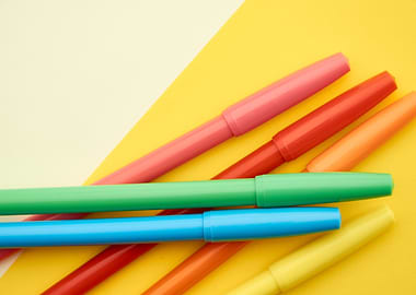 Colorful Markers on Yellow Background