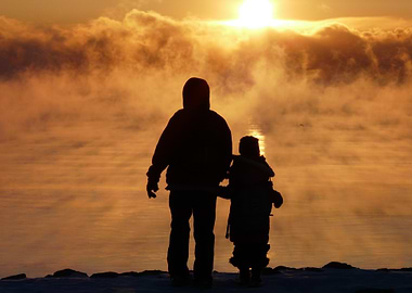 Silhouette of Father and Child at Sunrise