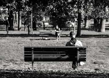Man sitting on bench in park
