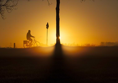 Silhouette of cyclist at sunrise
