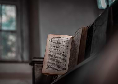 Open Antique Hymnal on Piano