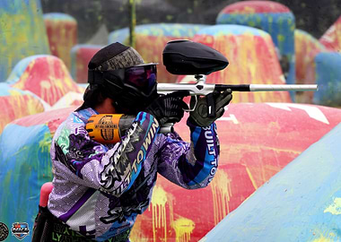 Paintball Player Aiming Gun in Action
