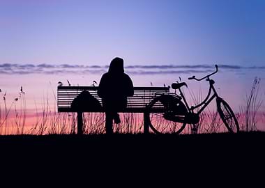 Silhouette of Person on Bench at Sunset