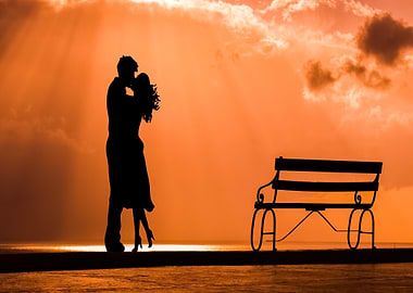 Silhouette of a couple kissing at sunset