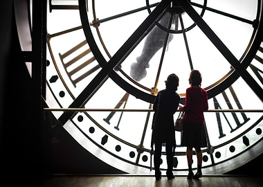 Two women looking at a clock