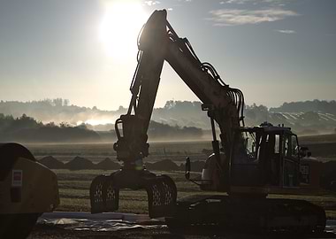 Excavator at Work in Misty Field