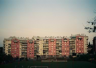 Pink apartment buildings near a soccer field